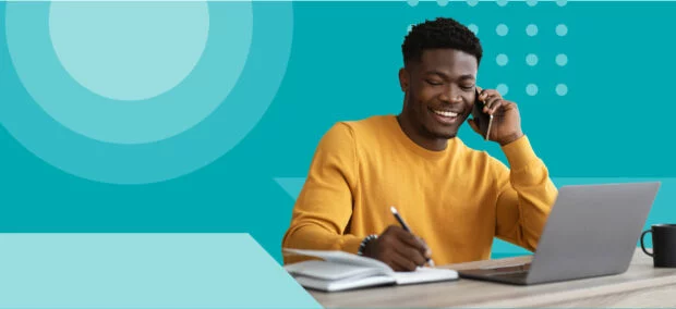 A focused man writing, set against a vibrant blue background