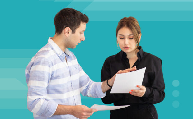 Featured image of two team members reviewing documents for content production workflow planning.