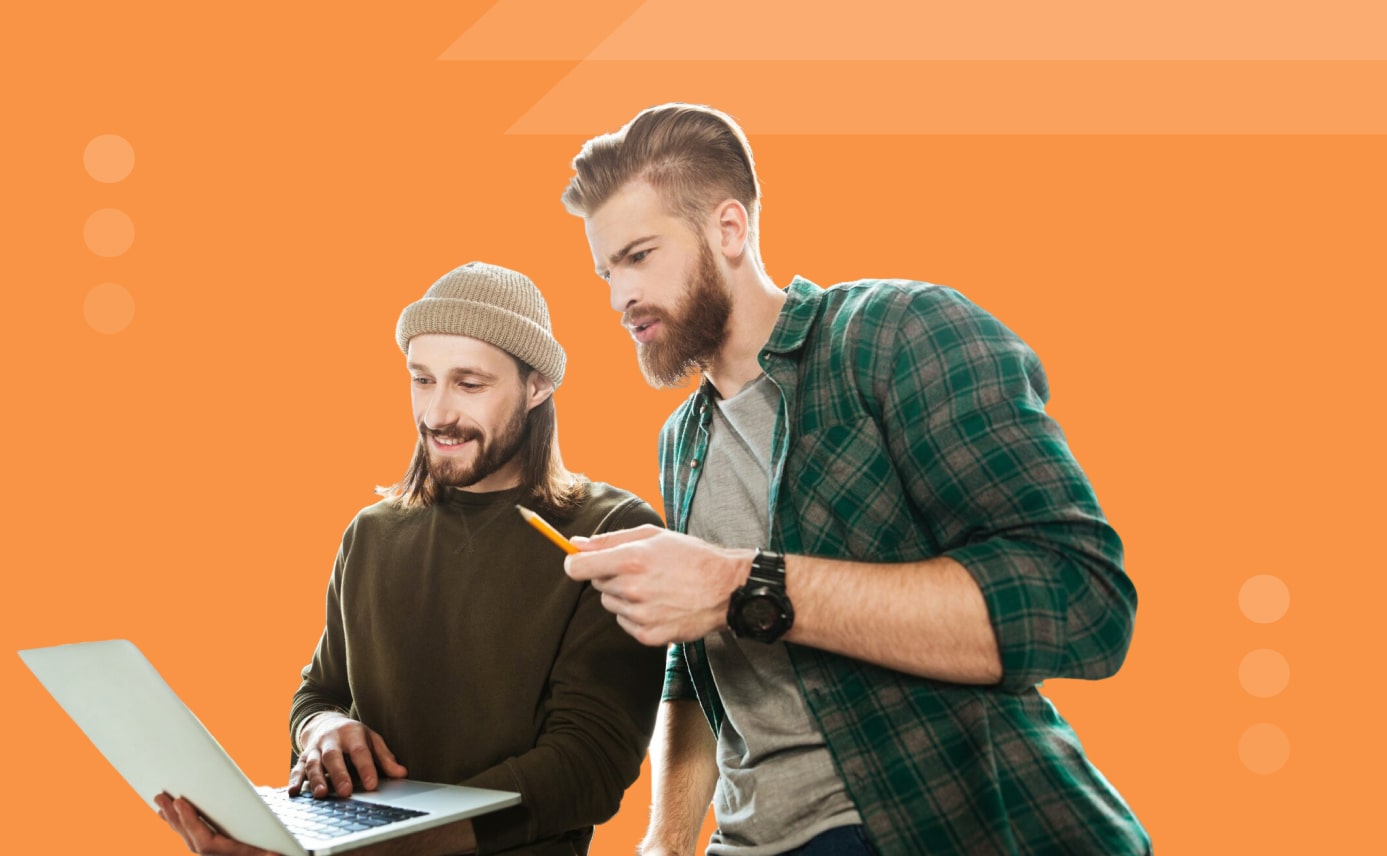 Two men collaborating on a laptop project on an orange background